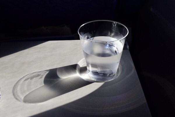 Clear glass of water on a table with gentle light